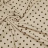 TESSUTO CREPE ELASTICIZZATO FONDO BEIGE CHIARO BOLLO VERDE