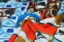 TESSUTO CREPE STRETCH FANTASIA GEOMETRICA ROSSO BLU