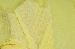 TESSUTO MAGLINA OPERATA ROMBO IN RILIEVO GIALLO
