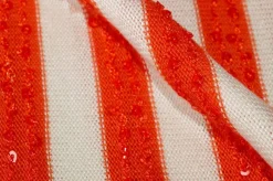 TESSUTO MAGLINA RIGATO CON PAILLETTES APPLICATE ARANCIO